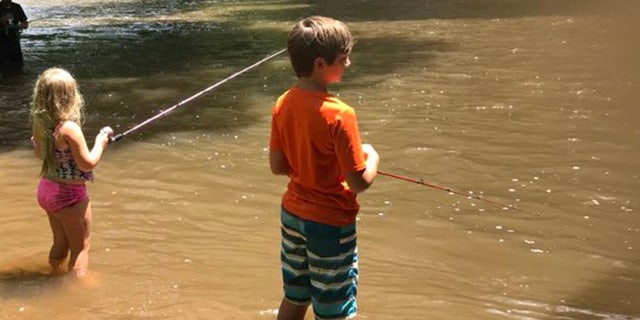 young logan fishing with sister