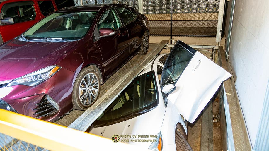 Pictured is a car crushed by a rotating parking garage platform in Portland