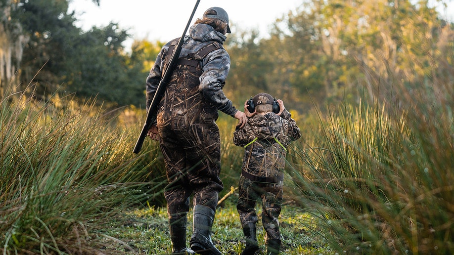 Father and son practice hunting