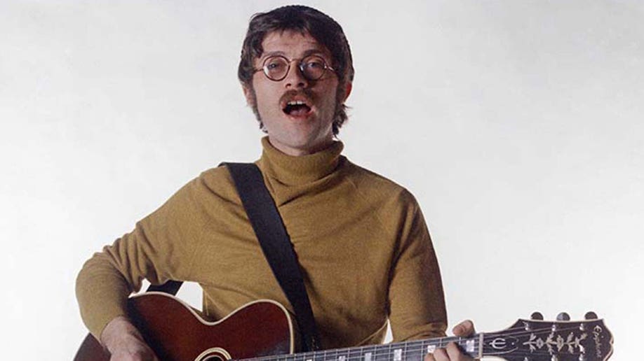 Robbie Robertson posing for a photo in New York