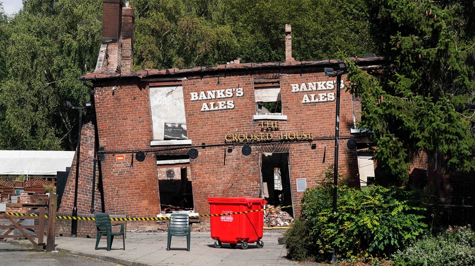 2 men arrested, accused of arson attack on England’s ‘Crooked House’ pub