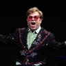 Elton John performs on stage