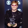 Elton John holds the Grammy Legend Award