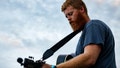 Christopher Anthony Lunsford, who goes by the stage name Oliver Anthony, warms up next to a loading dock behind the buildings lining Main Street before a surprise performance at the Rock the Block street festival on August 26, 2023 in Farmville, Virginia. - Fox News