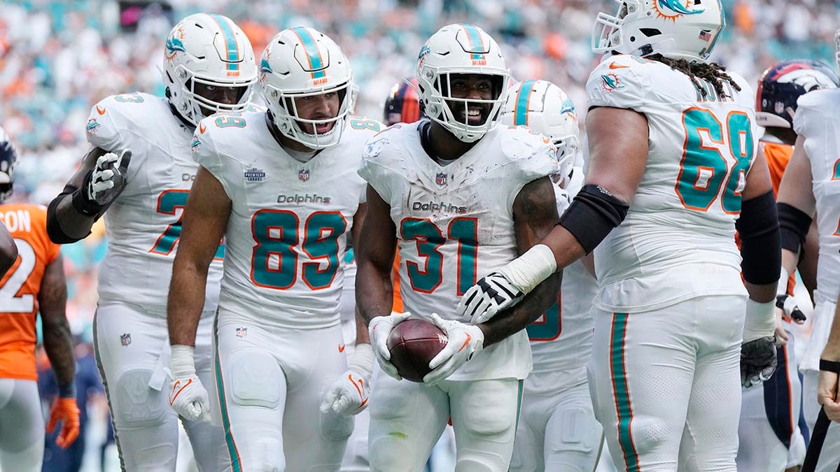 The Miami Dolphins celebrate after scoring a touchdown during the