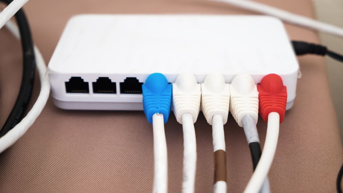 Cords are plugged into a WiFi router.