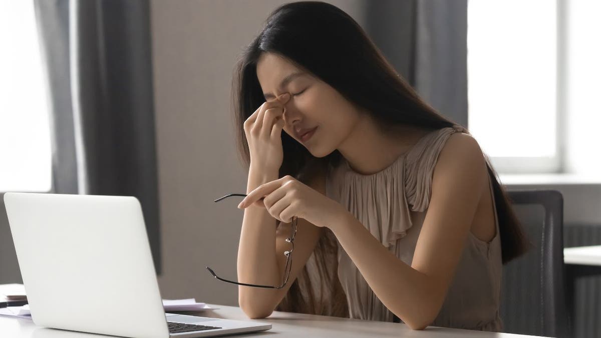 Upset woman sitting at her laptop.