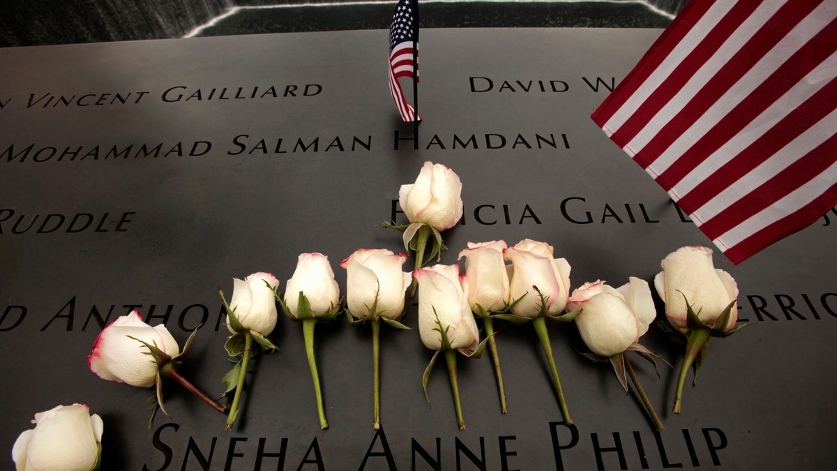 Flowers are placed on the memorial during ceremonies marking the 10th anniversary of the 9/11 attacks on the World Trade Center, in New York