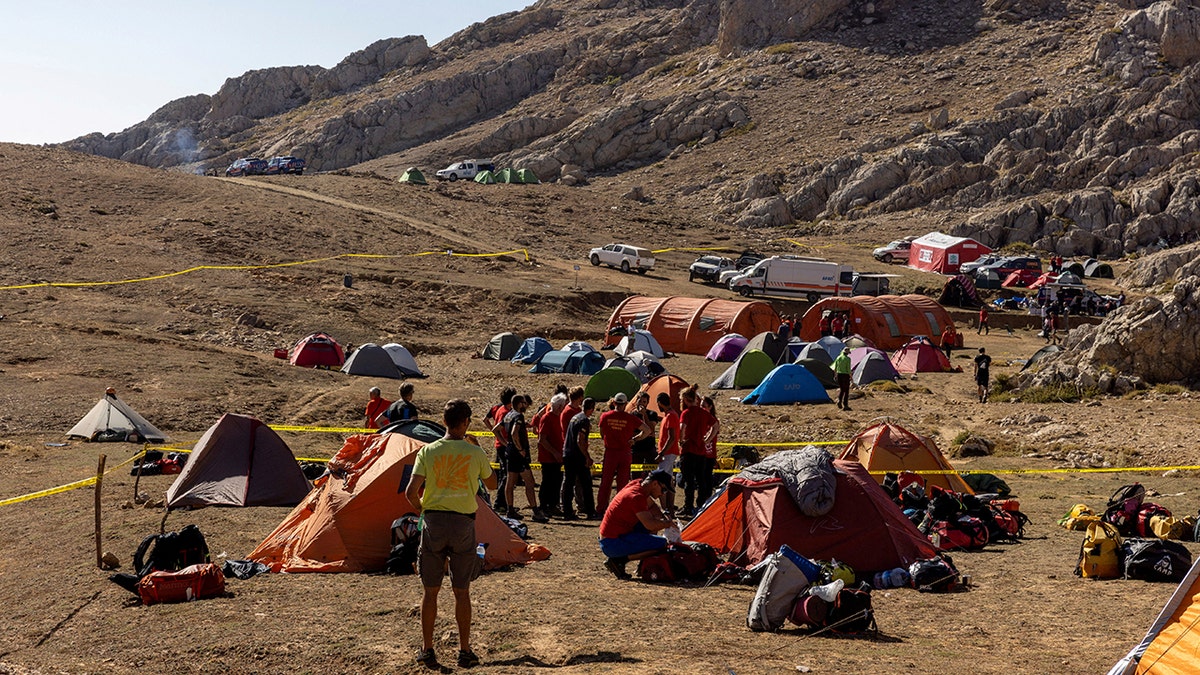 Dozens of people in a field