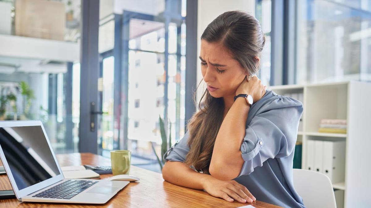 Stressed woman sitting at her desk.