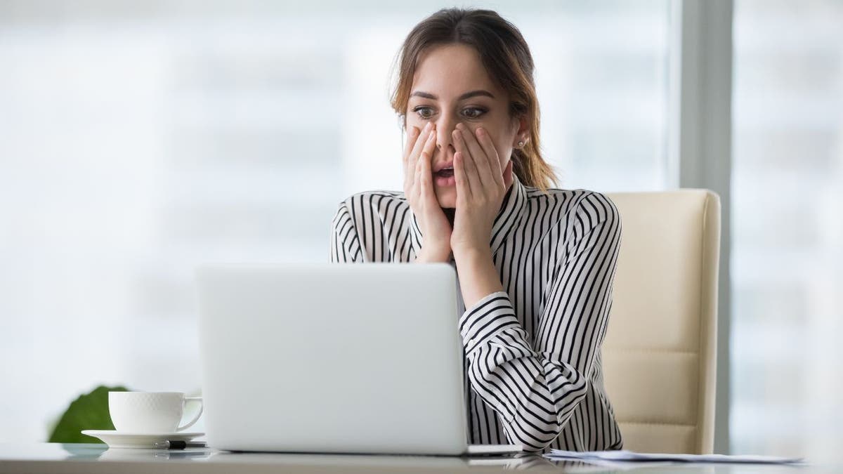 surprised woman looking at laptop