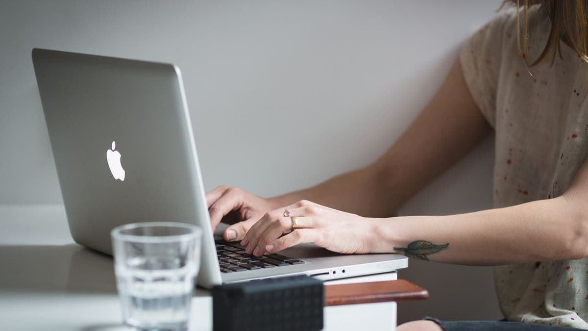 Woman typing on her laptop.