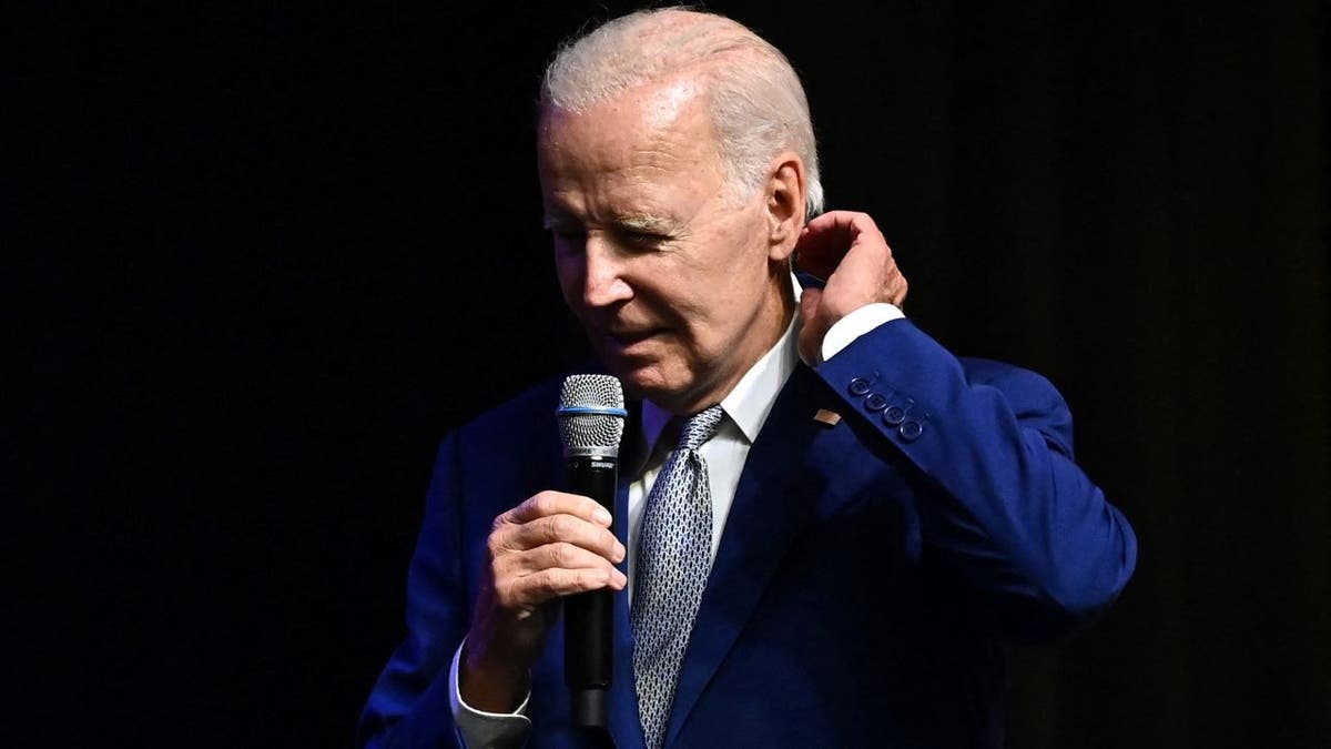 Biden holding mic at presser