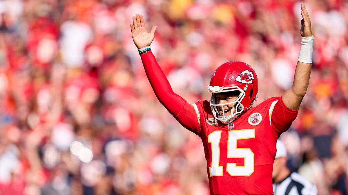 Patrick Mahomes with his hands raised