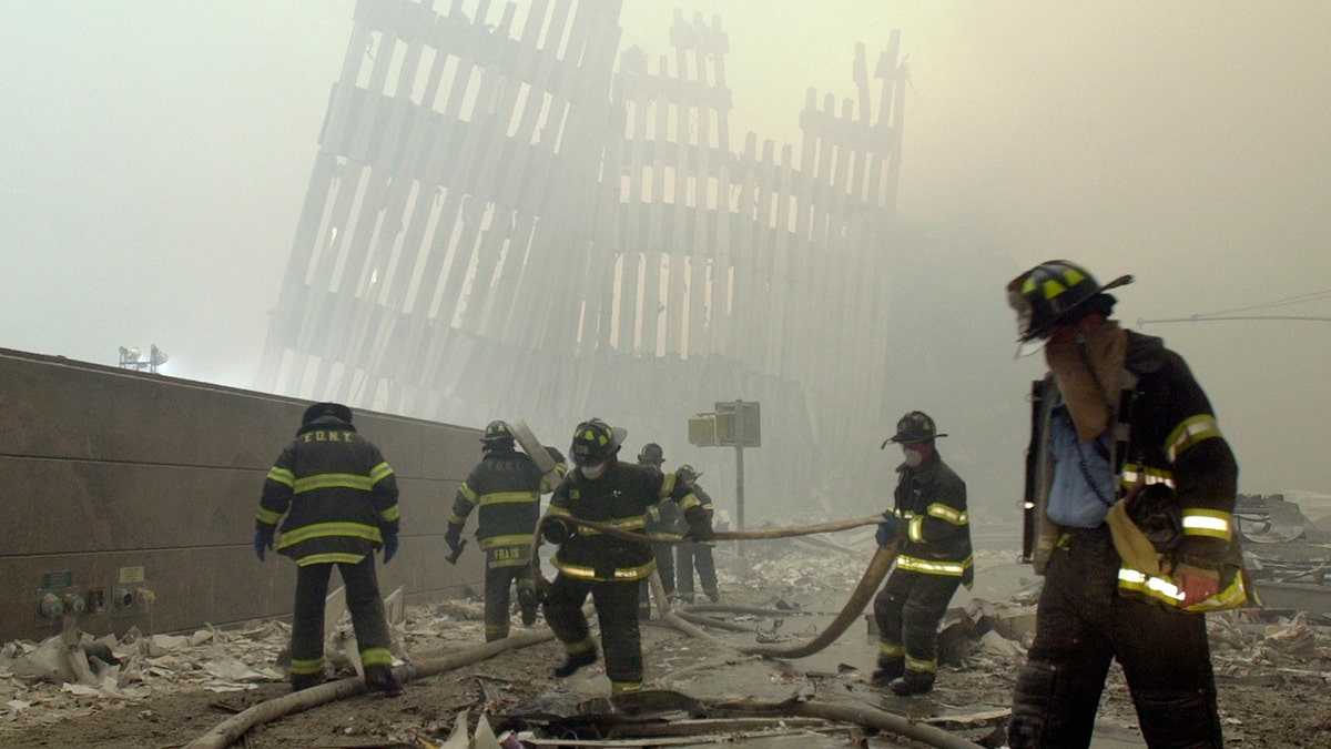 New York firefighters on 9/11/2001 walking on rubble at Ground Zero 