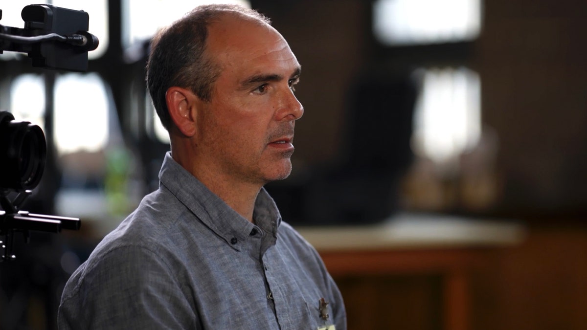 A close-up of Peter Reiss wearing a blue shirt