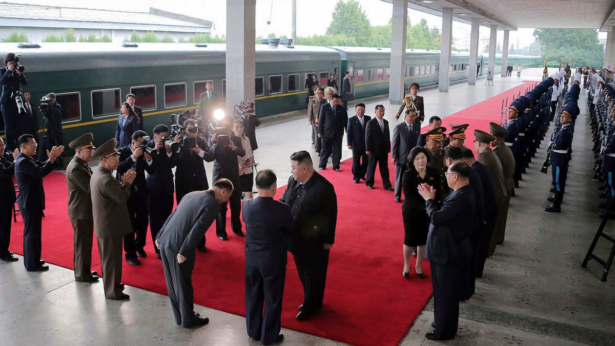 Kim, other officials at a train station