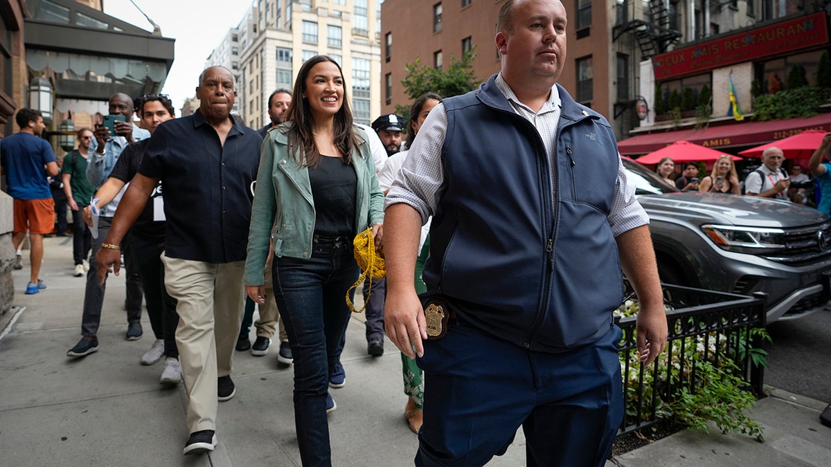 AOC joins thousands in New York climate change march with furious message for Biden  at george magazine
