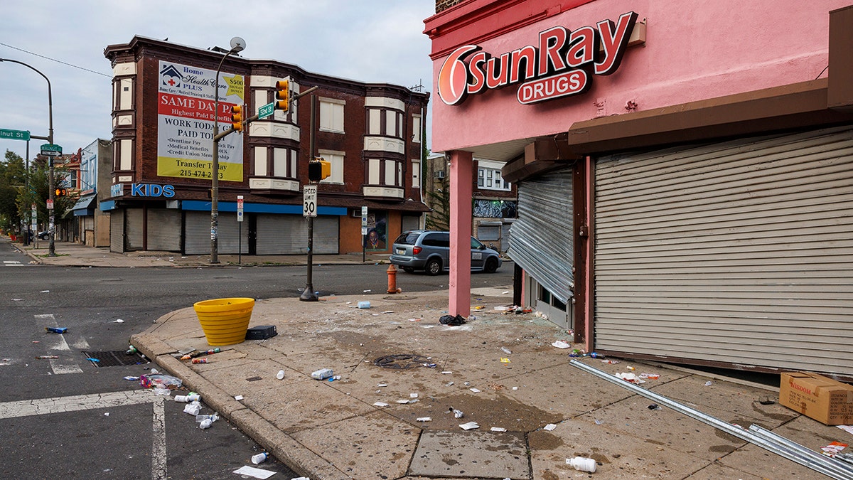 A drug store with a broken door gate