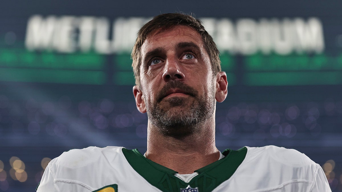 Aaron Rodgers listens to the anthem