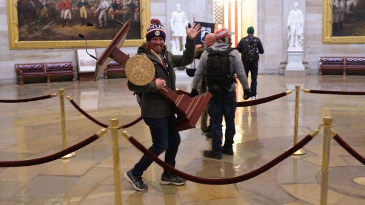 Adam Johnson pictured carrying Nancy Pelosi's lectern in photo from court documents