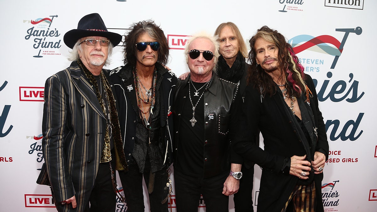 Brad Whitford, Joe Perry, Joey Kramer, Tom Hamilton and Steven Tyler pose together on the red carpet