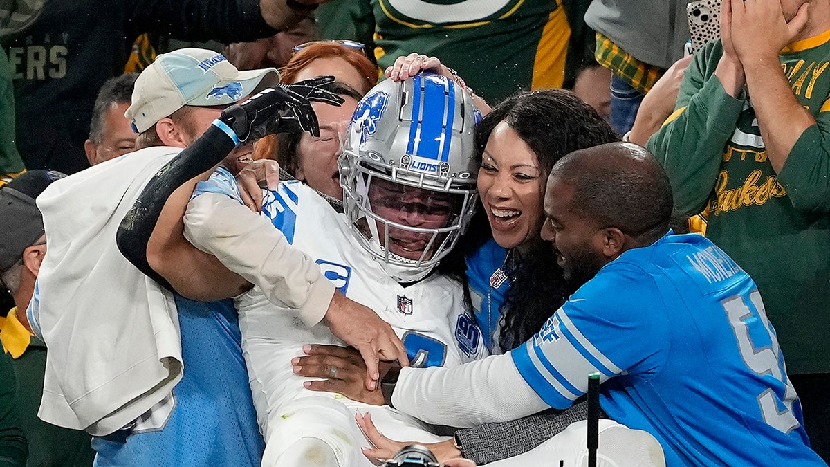 Amon-Ra St. Brown with Lions fans