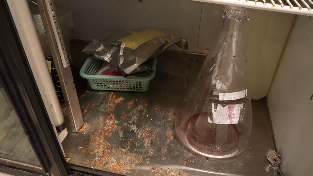 A beaker on dirty shelf in biolab in Fresno