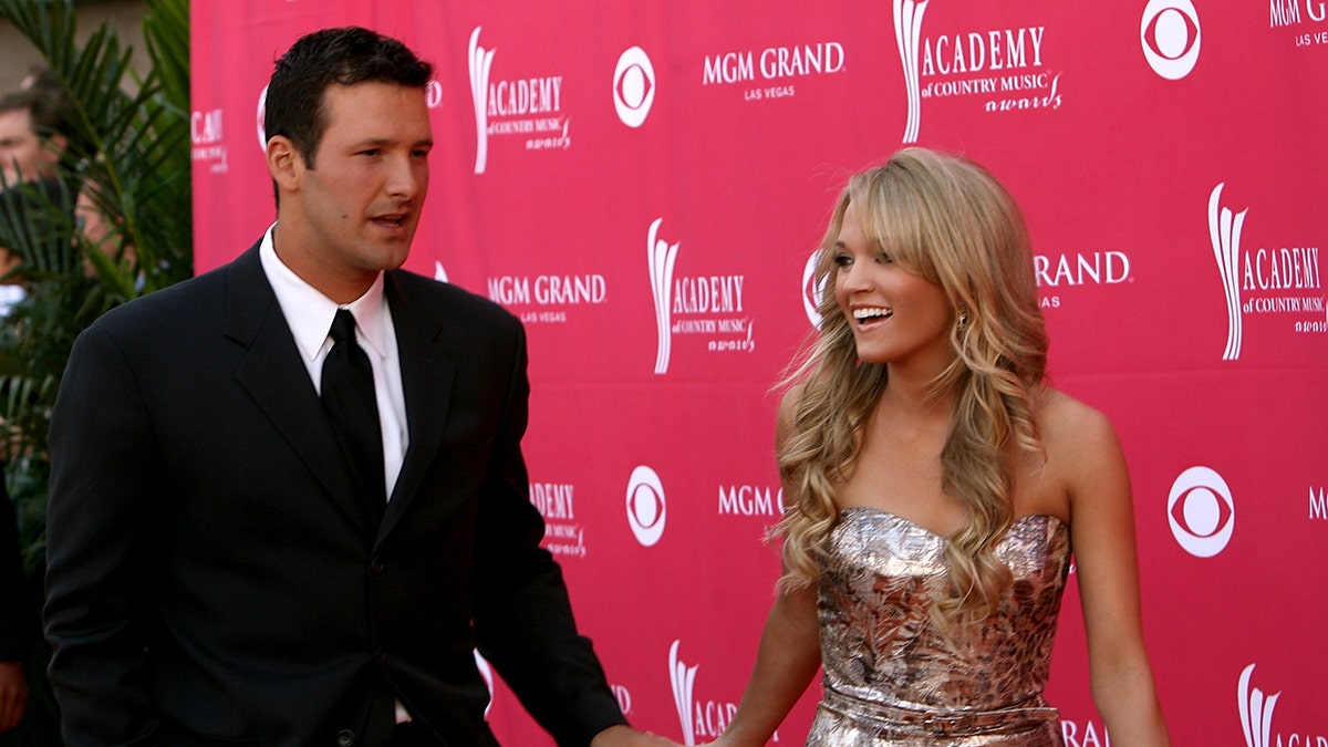Tony Romo and Carrie Underwood on a red carpet