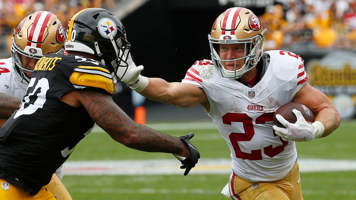 Christian McCaffrey stiff arms Steelers defender