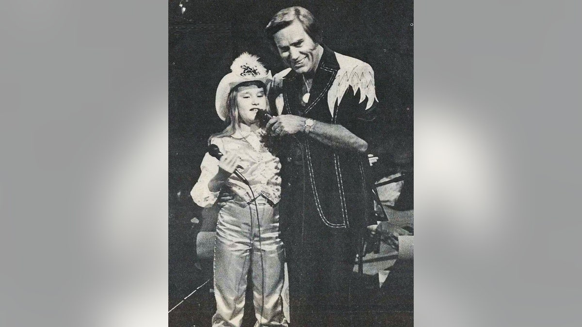 George Jones holding a mic to Georgette Jones