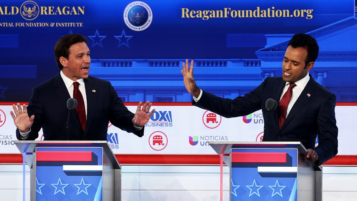 Vivek Ramaswamy (R) addresses Ron DeSantis (L) during second Republican debate