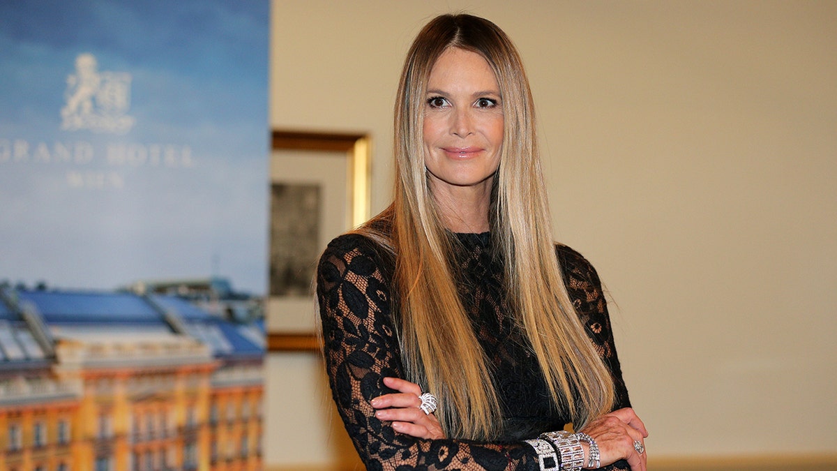 Elle Macpherson posing with arms folded