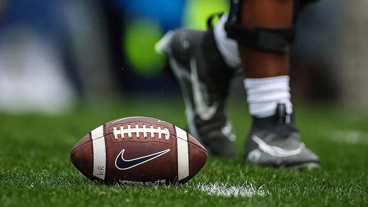 A football sits on the turf