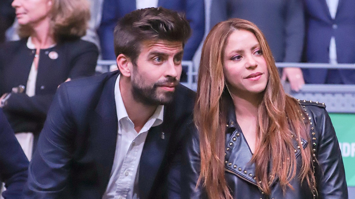 Gerard Pique and Shakira attend a game