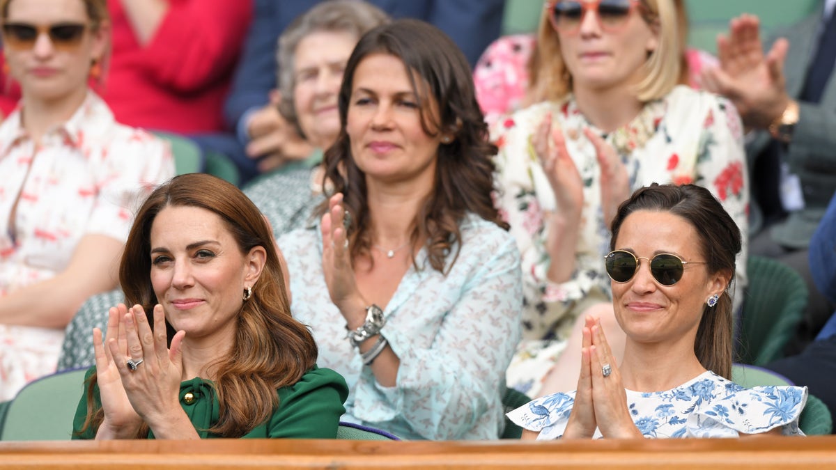 Kate Middleton and Pippa Middleton applauding from a crowd