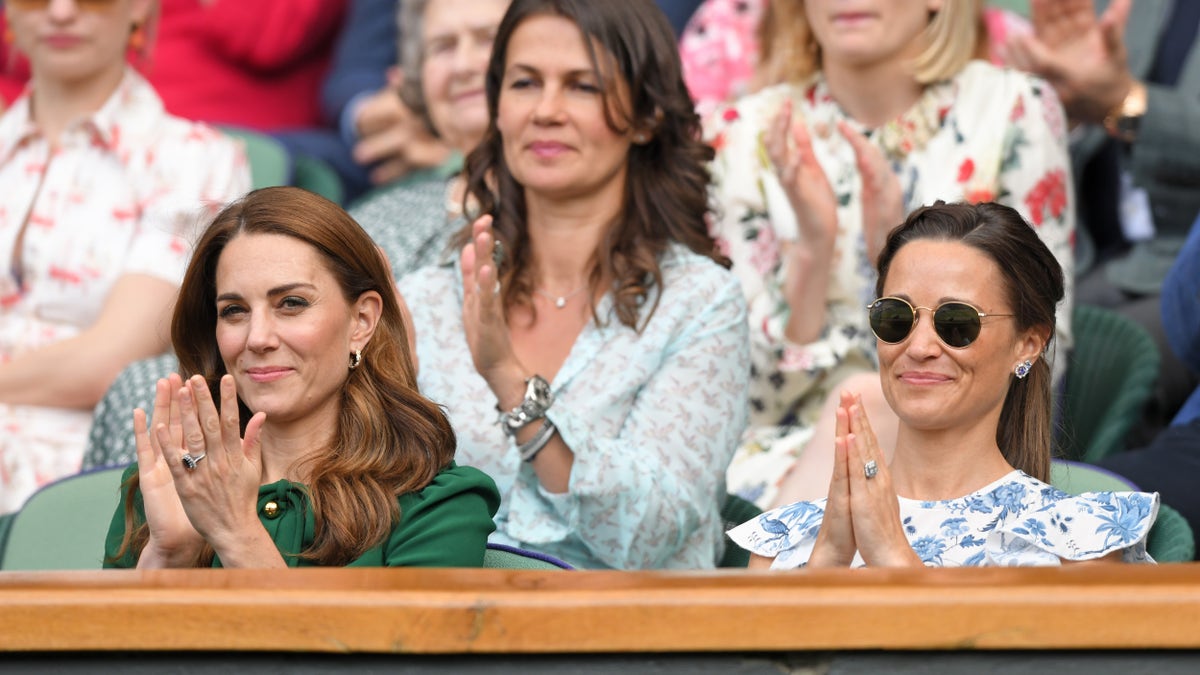 Kate Middleton and Pippa Middleton applauding from a crowd