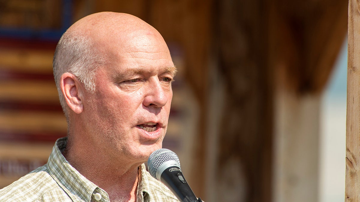 Greg Gianforte speaks into microphone