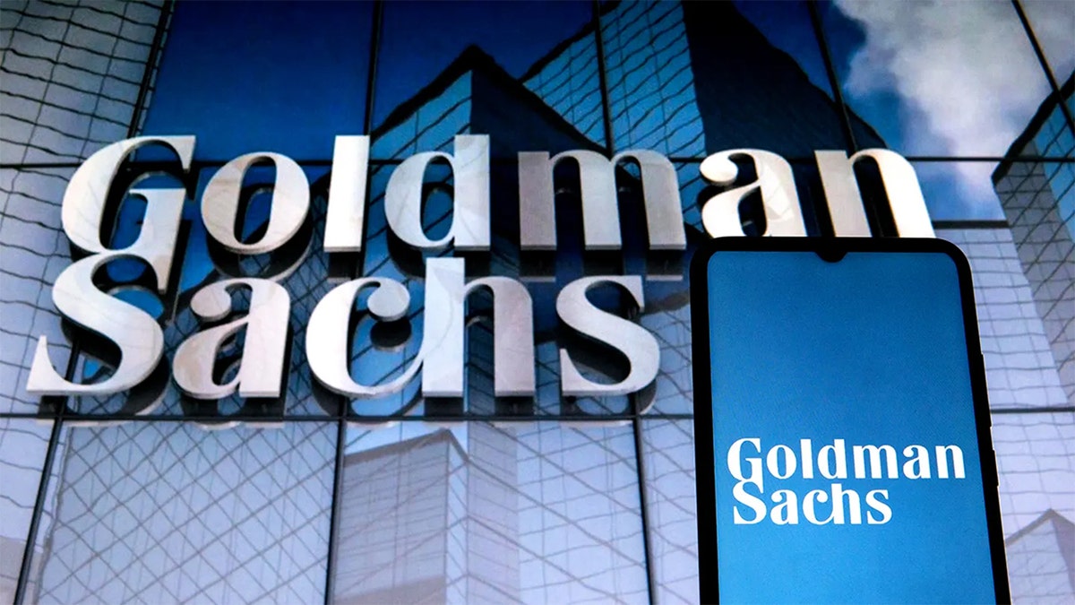 Photo of the Goldman Sachs name and a phone with the name on the screen.