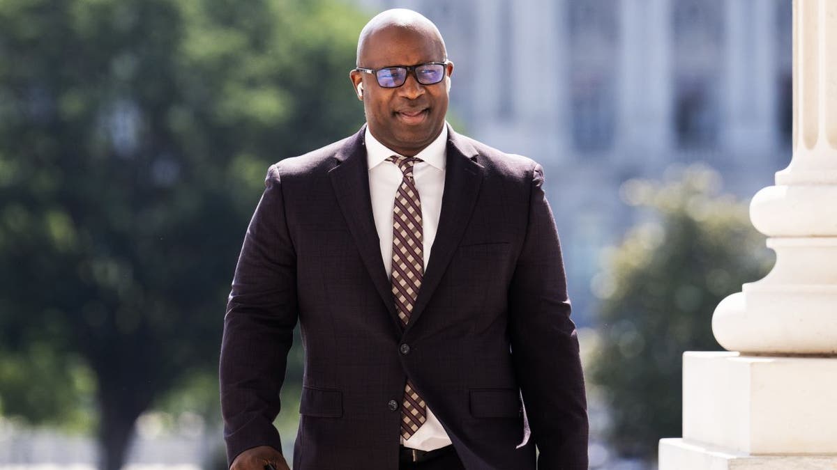 Rep. Bowman walking in a suit