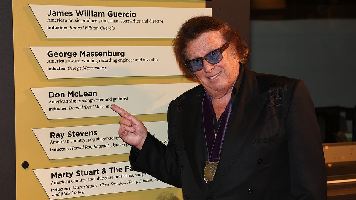 Don McLean at Musicians Hall of Fame pointing at his name