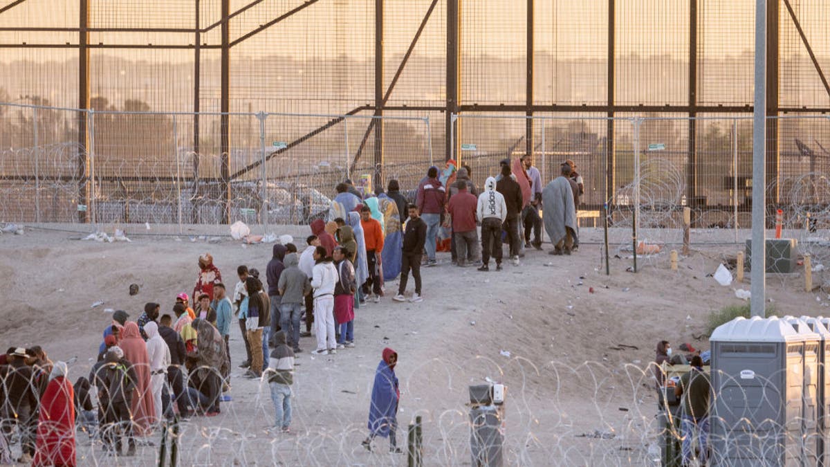 Migrants line up at the border in El Paso
