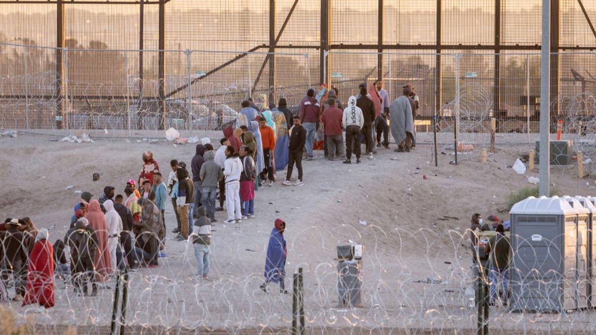 Migrants line up at the border in El Paso