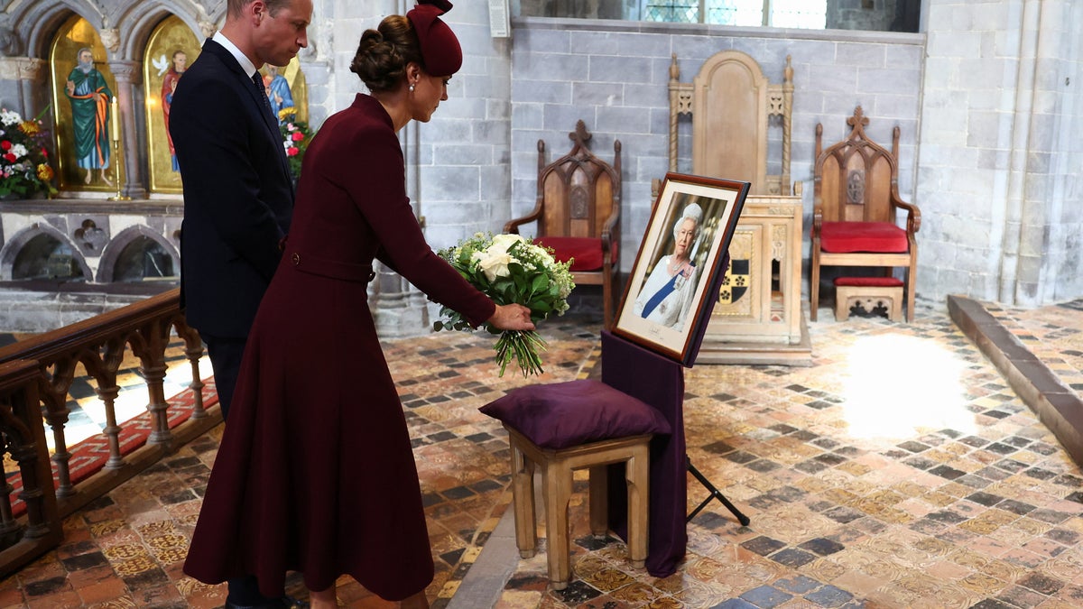 Prince William Princess Kate placing flowers 
