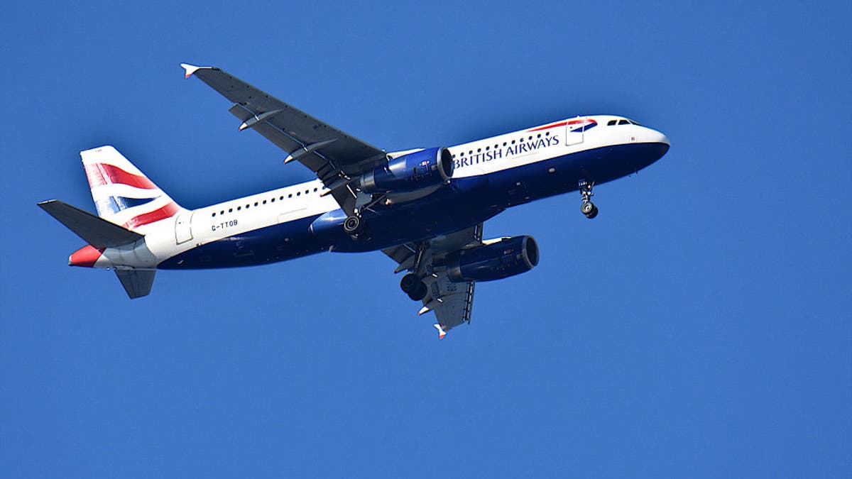 British Airways plane flies in the sky