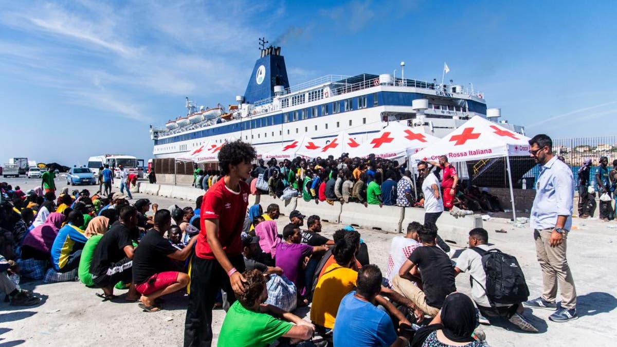 Migrants processing after arrival in Italy