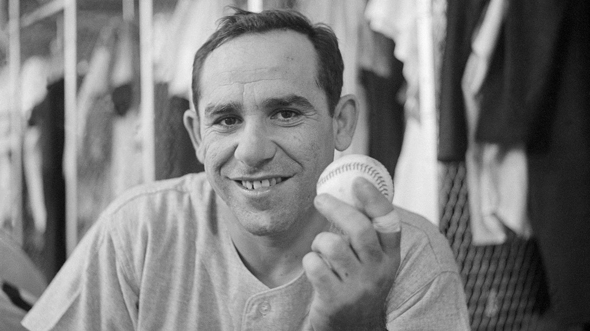 Yogi Berra poses for a picture