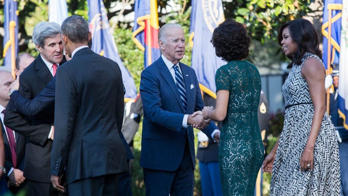 US Vice President Joe Biden (C) shakes hands with wife of Italian Prime Minister Matteo Renzi