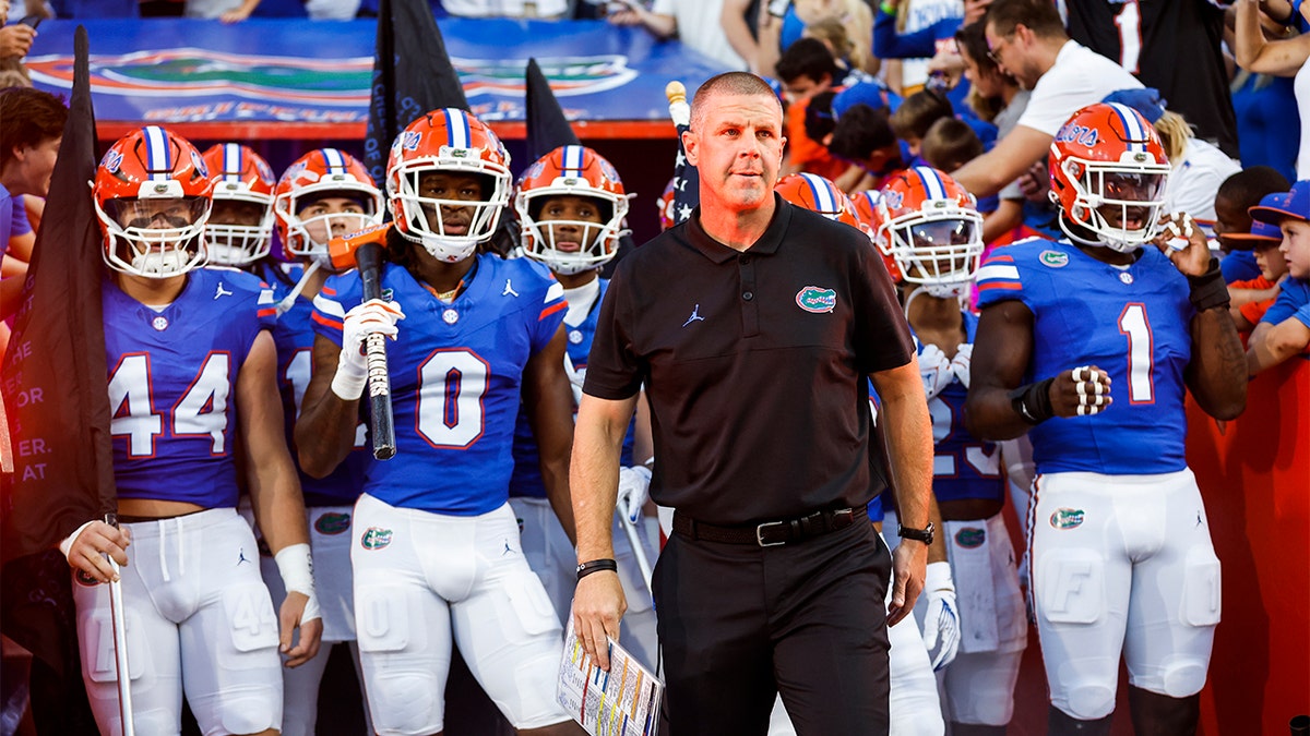 Billy Napier leads his team onto the field