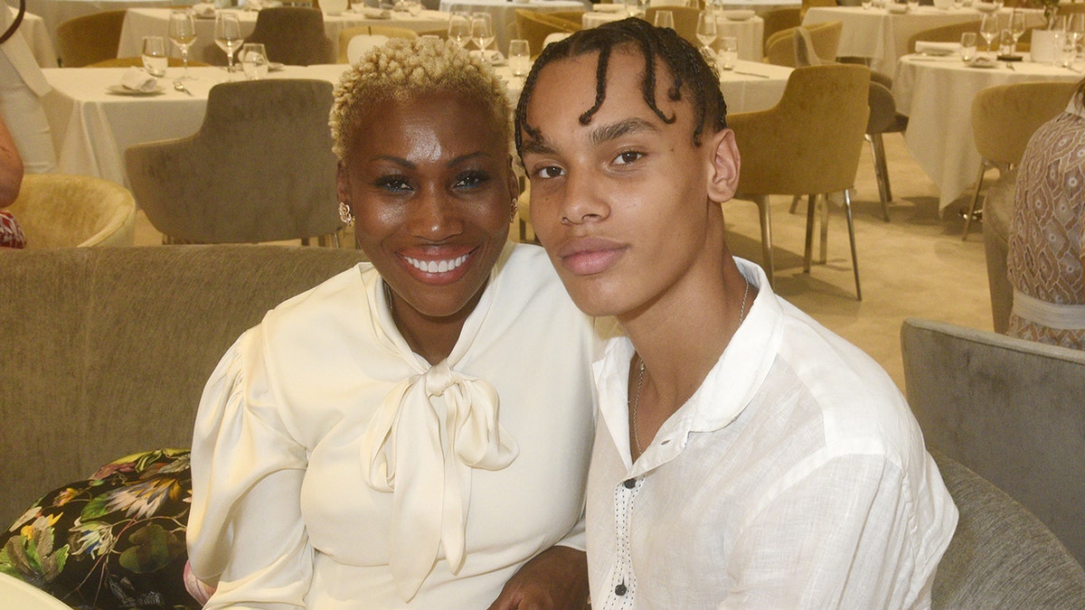 Alexandre Grimaldi wearing a white shirt sitting next to his mother wearing a matching white blouse